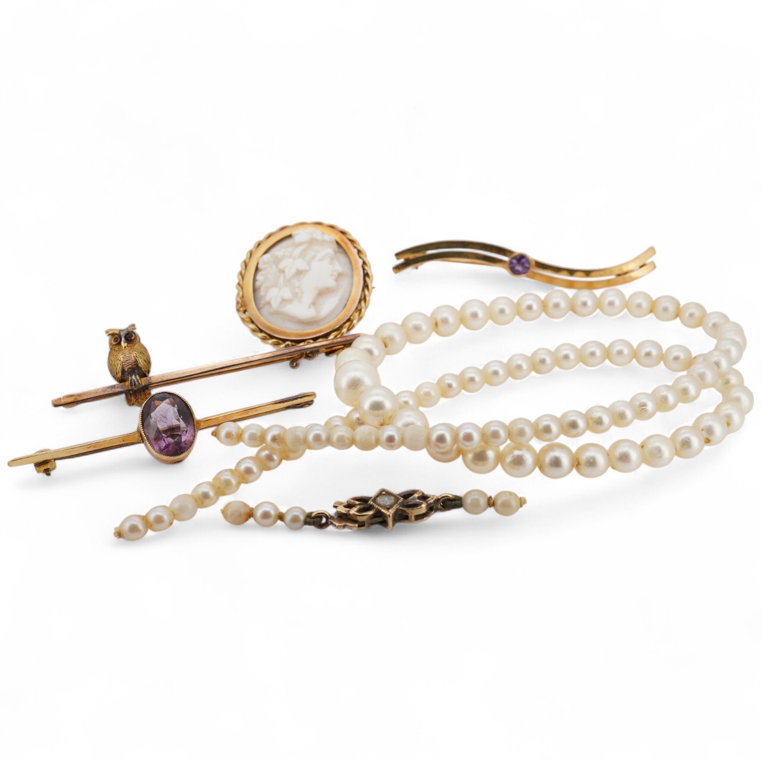 A 9ct owl bar brooch, with cabochon eyes, 50mm, a 1960's 9ct gold and amethyst set bar brooch, an 18ct and amethyst set bar brooch, a cameo brooch(a.f.) and a cultured pearl necklace with 9ct gold clasp.